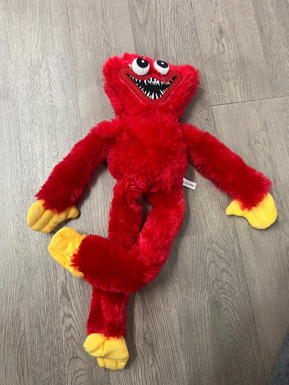 Red Fuzzy Monster Plush Toy with Yellow Hands and Feet